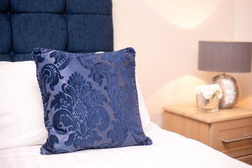 a blue pillow sitting on top of a bed at MARS Hotel Seaview Blackpool in Blackpool