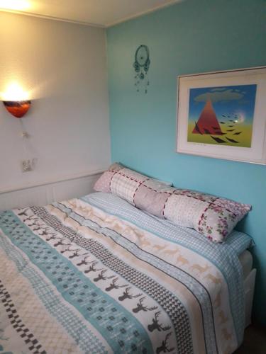 a bedroom with a bed with a blanket on it at Joy in Egmond-Binnen