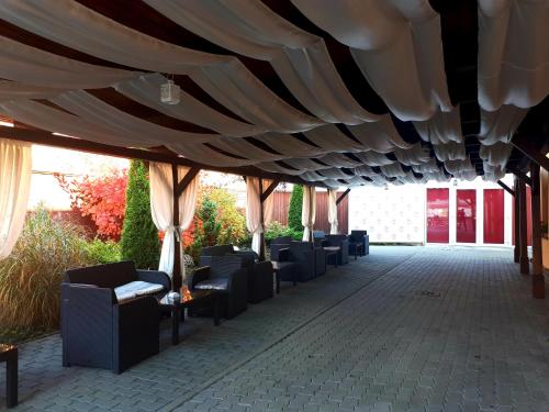 a row of chairs sitting under a tent at Hotel Dennis in Mediaş