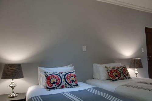 two beds sitting next to each other in a bedroom at ilanda Guest House in White River