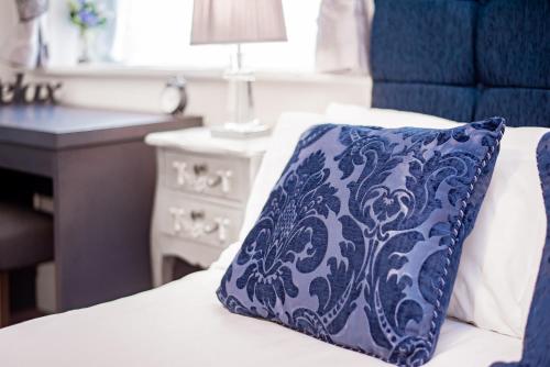 a blue pillow sitting on top of a bed at Trivelles Seaview Blackpool in Blackpool