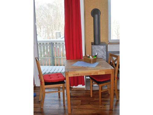 a dining room with a table and a wood stove at PONTUS Ferienwohnung FeWo4 in Zislow