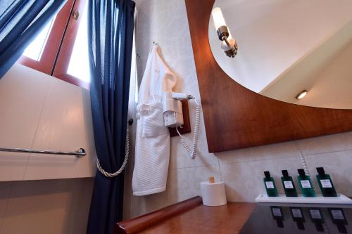 a bathroom with a phone hanging on the wall at Hotel Ziya in Podgorica
