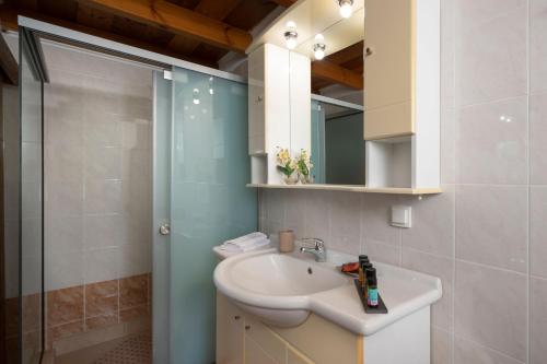a bathroom with a sink and a shower at Pagonas Traditional House in Mouríon