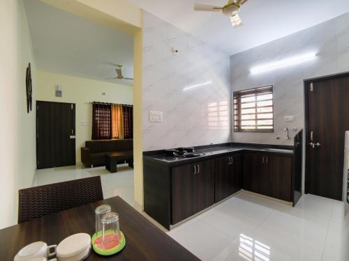 a kitchen with a table and a dining room at Daze Off Studio house in Bhuj