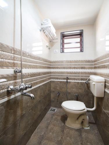 a bathroom with a toilet and a shower at Daze Off Studio house in Bhuj