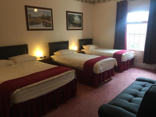 Ένα ή περισσότερα κρεβάτια σε δωμάτιο στο Holly Trees Hotel