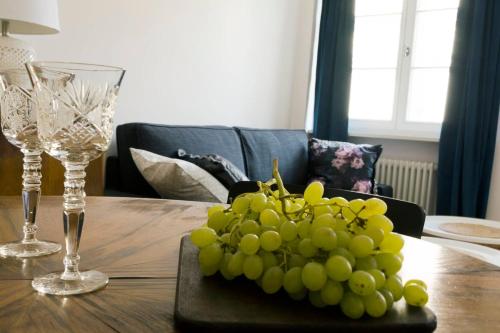 a bunch of green grapes on a wooden table at NEAR TO THE CASTLE in Warsaw