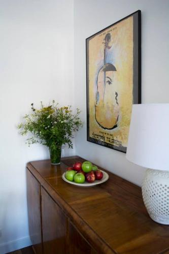 a table with a plate of fruit and a painting at NEAR TO THE CASTLE in Warsaw