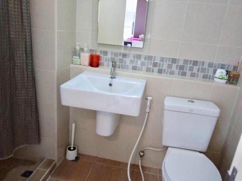 a bathroom with a white sink and a toilet at BanKunKoey A501 2 Bed Condo Mountain view Near Blue Ports 300m from the Beach in Hua Hin