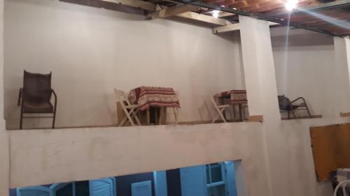 a group of chairs sitting on top of a wall at Pousada Preludio in Conservatória