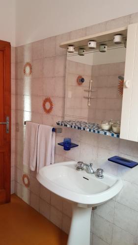a bathroom with a white sink and a mirror at Casa Clelia in Monsummano