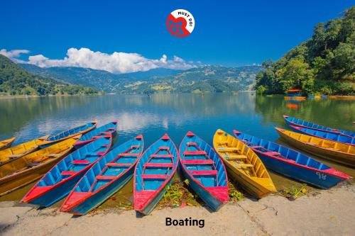 a group of boats sitting on the shore of a lake at Hotel Fewa Corner & Restro in Pokhara