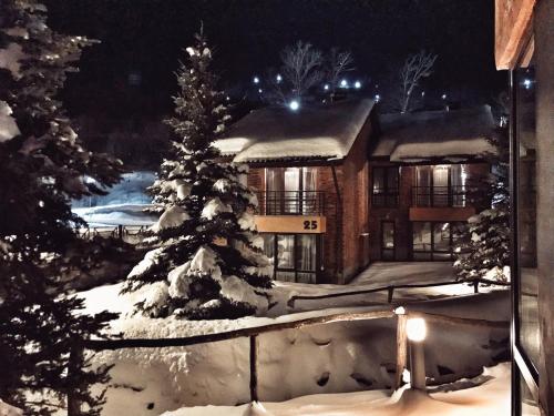 a house covered in snow at night at Teghenis Resort in Tsaghkadzor