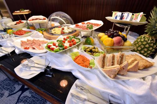 a buffet with many different types of food on a table at Hotel Ziya in Podgorica