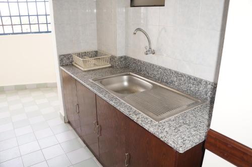 a kitchen with a sink in a counter top at AFamosa Purple Dream Residence Condotel homestay in Malacca