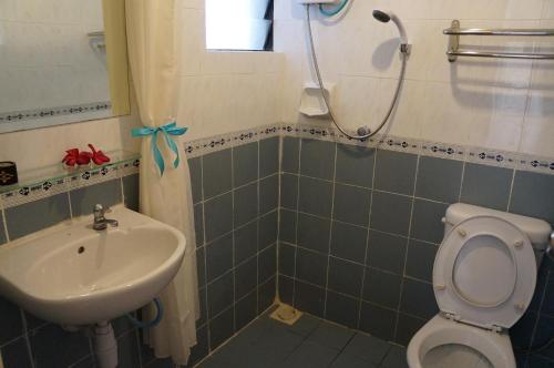a bathroom with a sink and a toilet and a shower at AFamosa Purple Dream Residence Condotel homestay in Melaka