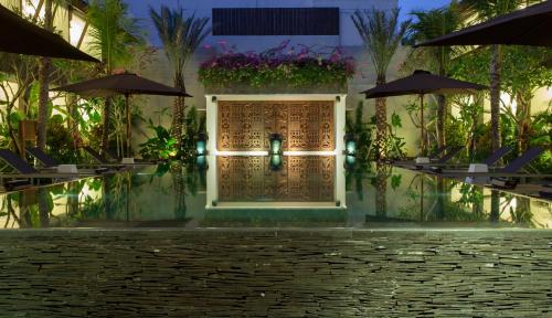 a building with a door in the middle of a courtyard at Kejora Suites in Sanur