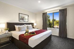 a large bedroom with a large bed and a window at Quest Mont Albert in Box Hill