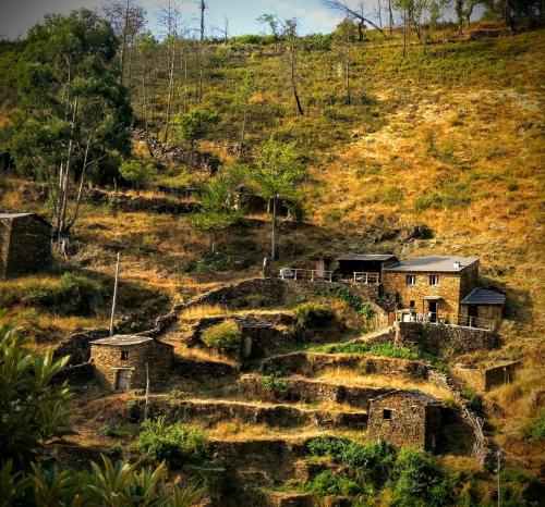 a house on the side of a hill at Refúgio do Fujaco in São Pedro do Sul