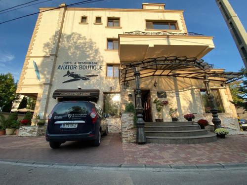 a car parked in front of a building at Hotel Aviator Boutique in Otopeni