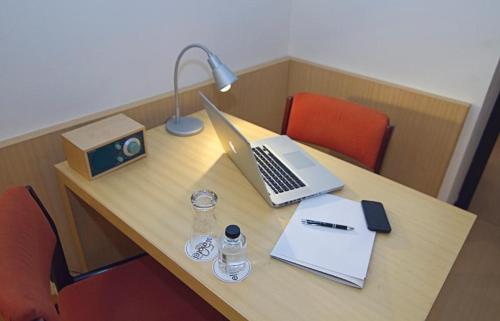 a desk with a laptop and a lamp on it at Hotel Emporda in Figueres