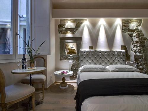 a bedroom with a large bed and a fireplace at Piccolo Signoria Apartment in Florence
