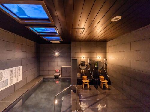 a room with a swimming pool with two toilets at Super Hotel Premier Akihabara in Tokyo