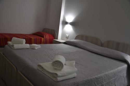 a bedroom with two beds with towels on them at Case Vacanze Blue Sea in Mascali