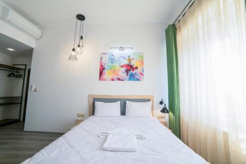 a bedroom with a large bed with white sheets at Maria Boutique Suits in Budapest