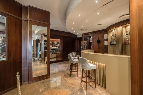 a bar in a store with chairs and tables at Hotel Mythos in Milan