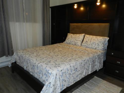 a bedroom with a bed with a white comforter at Montreal Olympic Parc in Montreal