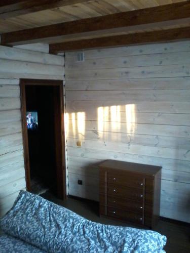 a bedroom with a bed and a wooden wall at Екомотель in Vulʼka