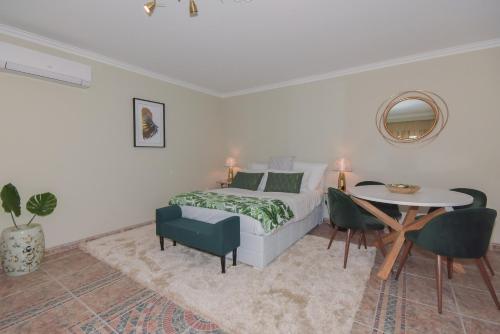 a bedroom with a bed and a table and chairs at Douro Prime Downtown in Vila Nova de Gaia