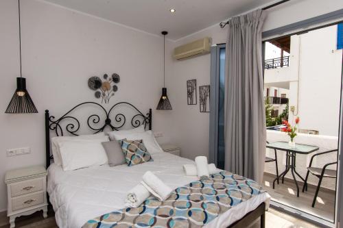 A bed or beds in a room at Naxos Enjoy Apartments