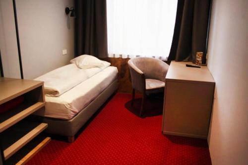 a small room with a bed and a chair at Casa Boca in Cluj-Napoca