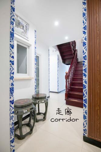 a living room with two stools and a staircase at 弱水咖啡国际青旅 Only Cafe and Backpacker in Chongqing
