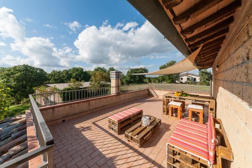 a patio with a bench and table on a roof at Agriturismo Podernuovo in Acquapendente
