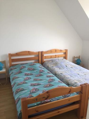 a bedroom with a bed with a wooden frame at Voltaire in La Turballe