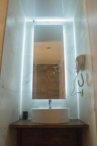 a bathroom with a sink and a mirror at Maria Boutique Suits in Budapest