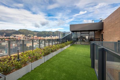 a roof garden on a building with green grass at Hyatt Place Bogota Convention Center in Bogotá
