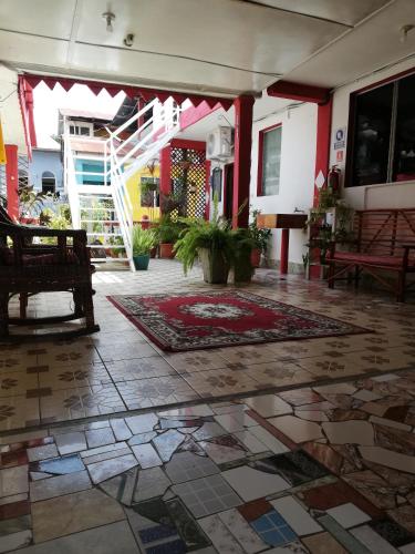 a lobby with a rug on the floor of a building at Hotel La Union in Flores