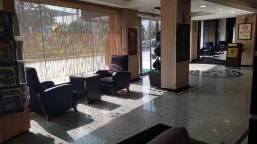 a lobby with couches and chairs in a building at Lioncity Hotel in Bursa