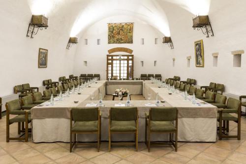 
a large room with tables and chairs and a large mirror at Parador de Tortosa in Tortosa
