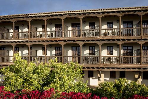 an exterior of a building with balconies and flowers at Parador de Tortosa in Tortosa