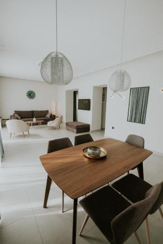 a living room with a wooden table and chairs at Pefkaki Boutique Hotel Loutraki in Loutraki