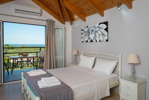 a bedroom with a bed and a balcony at Yiannis Studios in Tsilivi