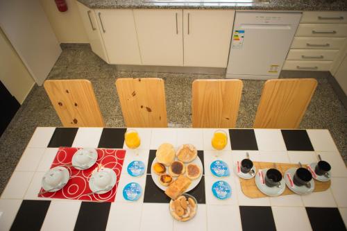 a checkered table with plates of food on it at BRUMA HOSTEL in Ponta Delgada