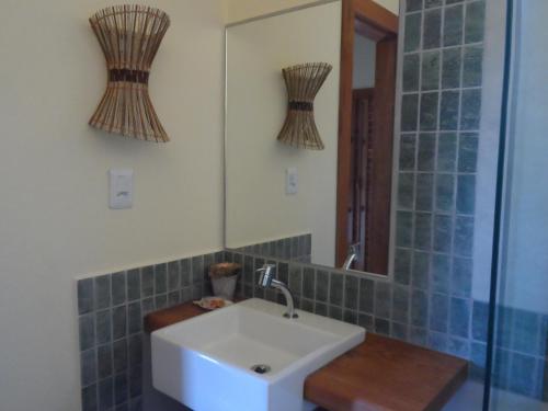 a bathroom with a sink and a mirror at Cais Dourado Pousada in Barra Grande