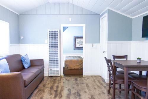 a living room with a couch and a table at Ocean Echo Inn & Beach Cottages in Santa Cruz
